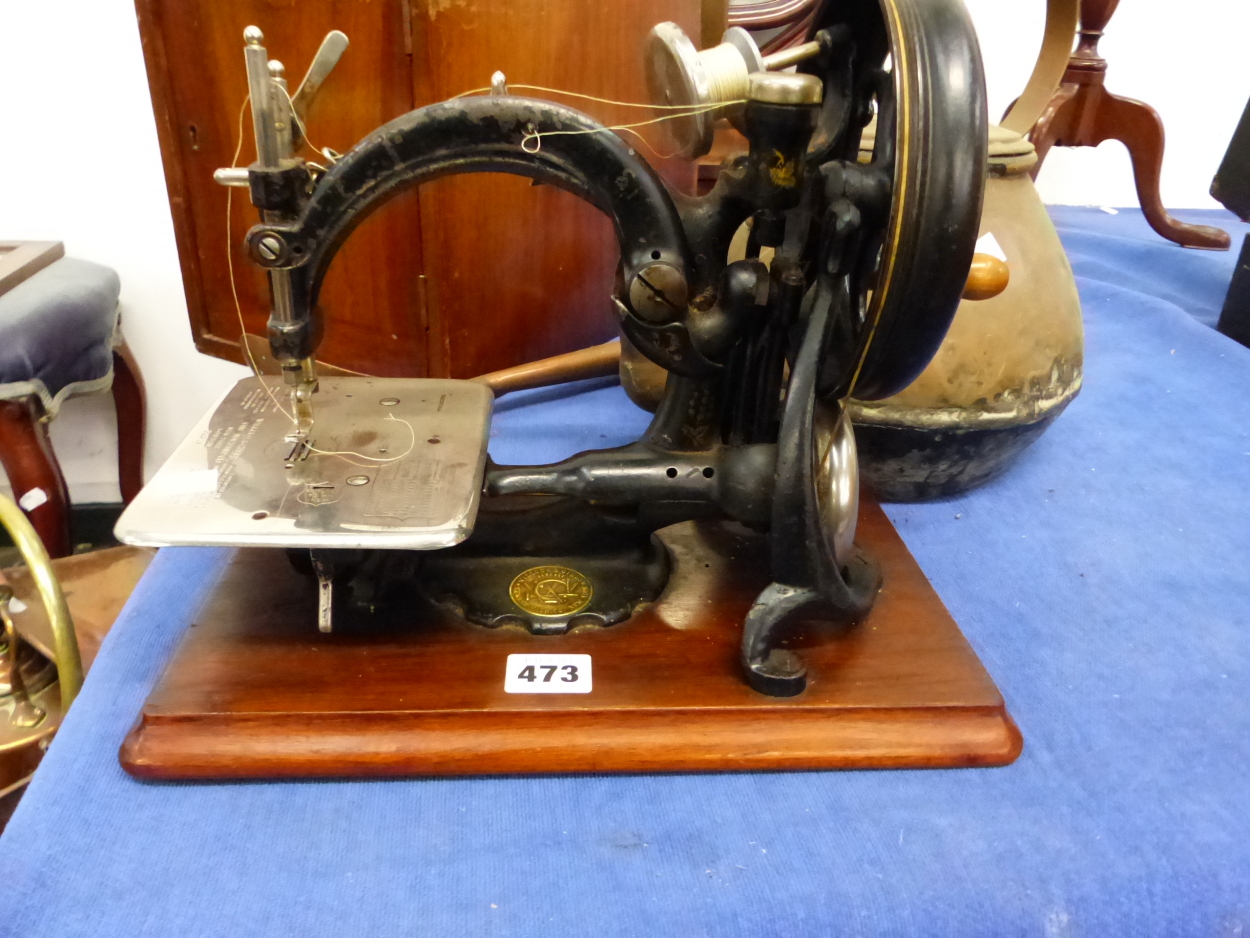 A WILLCOX AND GIBBS SEWING MACHINE WITH MAHOGANY TRANSIT CASE, A LARGE BRASS KETTLE, AND A COPPER