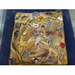A QUANTITY COSTUME BROOCHES ON A TAPESTRY CUSHION