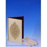 AN ANTIQUE IVORY NOTE CASE CARVED WITH A VIGNETTE OF A BUNCH OF FLOWERS TOGETHER WITH FOUR STYLUSES