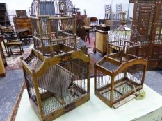 TWO VINTAGE ORNAMENTAL WOOD AND WIRE BIRD CAGES. LARGEST 36 x 83 x 22cms.