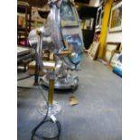 A PAIR OF LARGE VINTAGE CAST AND POLISHED ALUMINIUM FLOODLIGHTS WITH STANDS, THE CIRCULAR FRAME TO