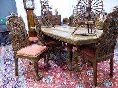 A BURMESE TEAK DINING TABLE WITH SINGLE LEAF AND ROUNDED RECTANGULAR ENDS CARVED WITH BANDS OF