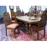 A BURMESE TEAK DINING TABLE WITH SINGLE LEAF AND ROUNDED RECTANGULAR ENDS CARVED WITH BANDS OF