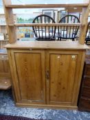 AN ANTIQUE PINE SIDE CABINET WITH RAISED SHELF OVER.