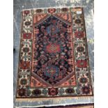 TWO ANTIQUE PERSIAN HAMADAN RUGS, 145 x 107 AND 197 x 135cms (2)