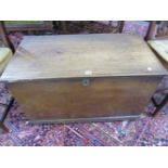 AN ANTIQUE ELM COFFER WITH PLANK TOP AND SIDES ABOVE CASTOR FEET. W 83.5 x D 45 x H 52cms.
