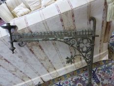 A PAIR OF ANTIQUE GOTHIC REVIVAL IRON CANDLESTICK BRACKETS, THE BAR BACK PLATES JOINED TO THE