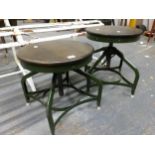 A PAIR OF INDUSTRIAL STYLE STOOLS WITH ADJUSTABLE AND REVOLVING CIRCULAR MAHOGANY SEATS, EACH ON FOU