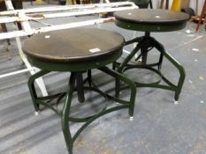 A PAIR OF INDUSTRIAL STYLE STOOLS WITH ADJUSTABLE AND REVOLVING CIRCULAR MAHOGANY SEATS, EACH ON FOU