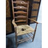 A LATE 19th/EARLY 20th C. CLISSETT LADDER BACKED ELBOW CHAIR WITH RUSH SEAT.`