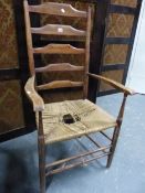 A LATE 19th/EARLY 20th C. CLISSETT LADDER BACKED ELBOW CHAIR WITH RUSH SEAT.`