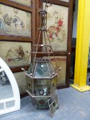 TWO ARTS AND CRAFTS WROUGHT IRON AND LEADED GLASS HALL LANTERNS / LIGHTS FLARING FROM THE TOPS TO