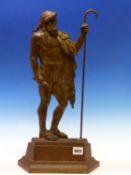 A BRONZE DOORSTOP CAST AS A CLASSICAL MAN STANDING WITH A SHEPHERDS CROOK IN HIS LEFT HAND. H