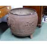 A LARGE CHINESE IRON CAULDRON CAST WITH FOUR PANELS OF FLOWERING LOTUS ABOUT THE RING HANDLED SIDES