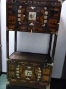 A KOREAN HARDWOOD CABINET WITH A CENTRAL SHELF BETWEEN CUPBOARDS EACH TOPPED BY THREE DRAWERS AND