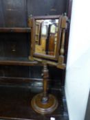A GEORGE III MAHOGANY FRAMED RECTANGULAR SHAVING MIRROR ADJUSTABLE ON A COLUMN AND LEAD WEIGHTED