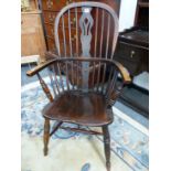 AN ANTIQUE WINDSOR CHAIR WITH TRIPLE PIERCED SPLAT FLANKED BY THREE STICKS, THE SADDLE SEAT ABOVE TU