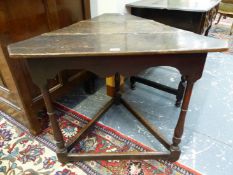 A GEORGE III OAK CRICKET TABLE, THE TRIPLE PLANK TRUNCATED TRIANGULAR TOP ABOVE A WAVY APRON, THE