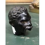 A 19th C. EBONY WALKING CANE HANDLE CARVED AS AN AFRICAN HEAD, ONCE WITH A LEVER TO MOVE THE EYES AN