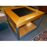 A PAIR OF TWO TIER COFFEE TABLES, BLOND WOOD FRAMING SQUARES OF BLACK ON THE TOPS, THE SQUARE GREY