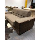 A TWO SEAT SETTEE WITH CALAMANDER WOOD BACK AND SIDES UPHOLSTERED IN BROWN CHEQUERED MATERIAL. W
