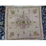A TURKISH PINK SILK PANEL WORKED IN GOLD THREAD AND SEQUINS WITH THE CENTRAL ROSETTE ENCLOSED BY