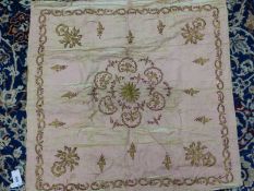 A TURKISH PINK SILK PANEL WORKED IN GOLD THREAD AND SEQUINS WITH THE CENTRAL ROSETTE ENCLOSED BY