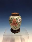 A CHINESE FAMILLE VERTE OVOID JAR, CARVED WOOD COVER AND STAND, THE BODY PAINTED WITH RED AND YELLOW