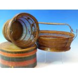 TWO BASKETS, ONE WITH AN OVAL WOODEN BASE AND WOVEN HANDLE. 29cms. THE OTHER WITH CIRCULAR WOODEN