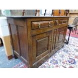 AN EARLY 19th C. OAK DRESSER WITH THREE DRAWERS OVER TWO PANELLED DOORS AND THE STILE FEET. W 152