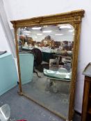 A 19th C. BEVELLED GLASS RECTANGULAR MIRROR IN A GILT FRAME WITH FOLIATE SIDES AND CRESTING BANDS OF
