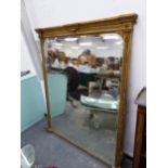 A 19th C. BEVELLED GLASS RECTANGULAR MIRROR IN A GILT FRAME WITH FOLIATE SIDES AND CRESTING BANDS OF