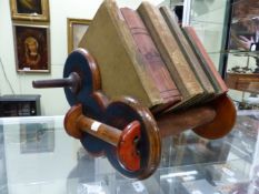 A BOOK RACK FORMED OF TURNED WOOD SPOOLS TOGETHER WITH NINE BOOKS. W 50cms.