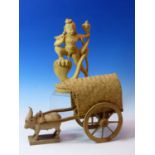 AN INDIAN CARVED WOOD BULLOCK DRAWN CART. W 30cms. TOGETHER WITH A CARVED WOOD FIGURE OF MANASA WITH