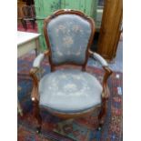 A VICTORIAN WALNUT SHOW FRAME ARMCHAIR, THE GREY GROUND FLORAL UPHOLSTERED BACK