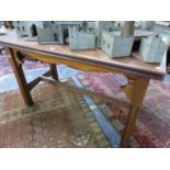 AN ARTS AND CRAFTS HARDWOOD AND PINE TABLE, T RECTANGULAR TOP ABOVE A WAVY APRON, THE SQUARE SECTIO