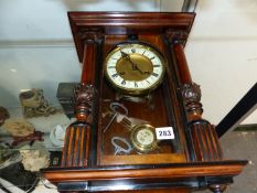 A WALL CLOCK COMPLETE WITH PENDULUM AND KEYS