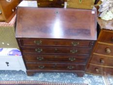 A GEORGE III MAHOGANY WRITING BUREAU WITH WELL FITTED STEPPED INTERIOR OVER FOUR DRAWERS ON