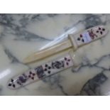 A BONE PAPER KNIFE AND SCABBARD DECORATED WITH PLAYING CARDS AND THEIR SUITS. W 27cms.