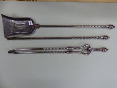 A SET OF THREE ANTIQUE POLISHED STEEL FIRE IRONS, EACH WITH BALUSTER HANDLES AND SPIRAL TWIST COLU