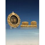 A CHINESE IVORY FLORAL CARVED OVAL EASEL BACKED FRAME. H 10cms. A DRAGON CARVED NEEDLE CASE,
