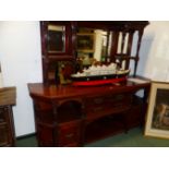 A LATE VICTORIAN MAHOGANY MIRROR BACKED SIDEBOARD, THE BASE WITH SHELVES OVER CUPBOARDS FLANKING TWO