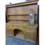 A 19th C. PINE DRESSER, THE ENCLOSED TWO SHELF BACK RECESSED ABOVE A BASE WITH A CENTRAL DRAWER OVER