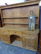 A 19th C. PINE DRESSER, THE ENCLOSED TWO SHELF BACK RECESSED ABOVE A BASE WITH A CENTRAL DRAWER OVER