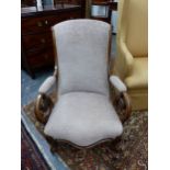 A 19th C. WALNUT ARMCHAIR, THE UPHOLSTERED BACK AND ELBOW RESTS ABOVE SCROLL HANDLES, THE SERPENTINE
