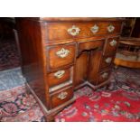 A GEORGE III AND LATER MAHOGANY KNEEHOLE DESK WITH A LONG DRAWER OVER THE CENTRAL RECESSED CUPBOARD