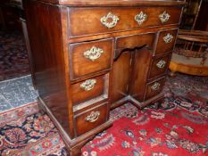 A GEORGE III AND LATER MAHOGANY KNEEHOLE DESK WITH A LONG DRAWER OVER THE CENTRAL RECESSED CUPBOARD