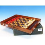 A JAQUES TRAVELLERS CHESS SET, THE MAHOGANY BOARD WITH LOCKS TO HOLD THE RED AND WHITE PIECES IN