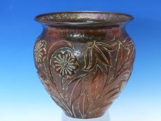 JOHN PEARSON, NEWLYN, A COPPER BOWL WORKED IN RELIEF WITH FLOWERS AGAINST A HAMMERED GROUND,