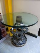 A GLASS TOPPED RETICULATED IRON TABLE ON A BRONZE CIRCULAR FOOT. Dia. 58 x H 60cms.